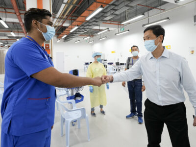 Health Minister Ong Ye Kung (right) visiting the CTF at F1 Pit Building