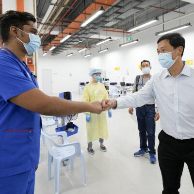 Health Minister Ong Ye Kung (right) visiting the CTF at F1 Pit Building